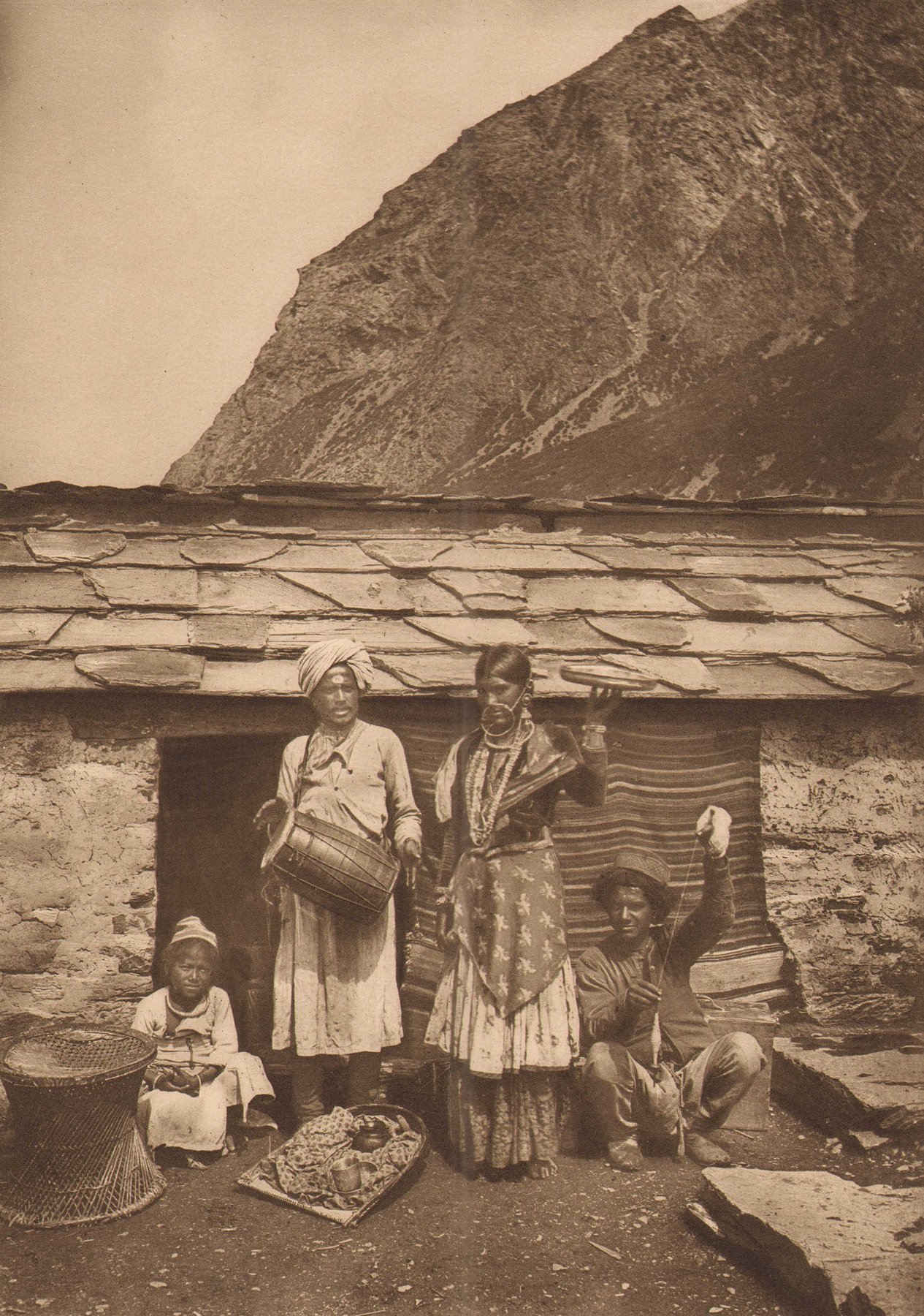 A Bhotia family outside a stone-and-slate house in Milam, in an 1894 photograph